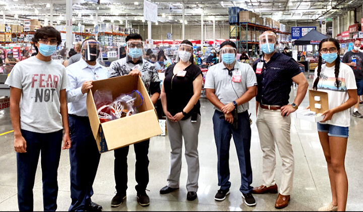 Costco employees wearing their new face shields.